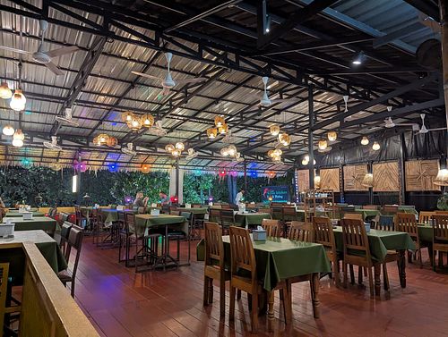 Rooftop/upper floor with view on trees, street and beach/sea at Kiran Kitchen Restaurant in Ao Nang