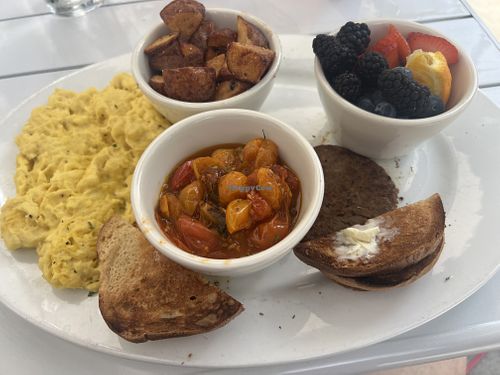 Vegan eggs & sausage with potatoes, tomatoes & fruit  at Blue Dog Bistro in Gulfport