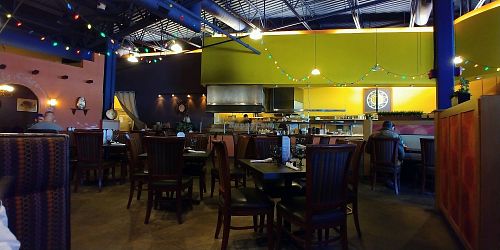 one section of seating, to the right out of the picture is a bar along with additional booth and table seating and then another smaller seating area  at Bueno Loco Restaurante in Falmouth