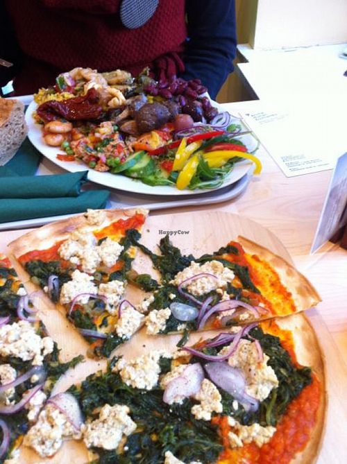 Antipasto plate (rear) and tofu and spinach pflammkuchen (front). at Veganz - Munich in Munich