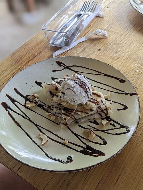Vegan Crepes - coconut ice cream, cashew nuts, banana and chocolate sauce. at Lemons and Tomatoes in San Vicente Palawan