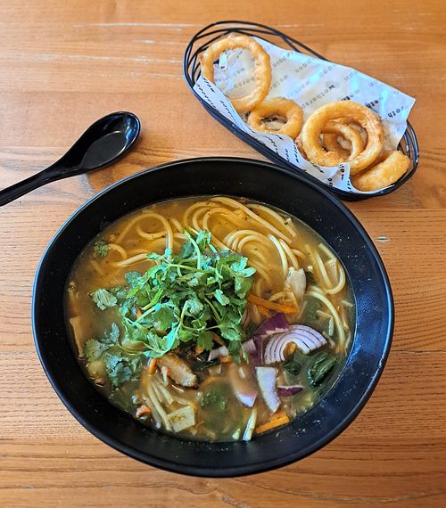 Vegan Ramen noodle bowl with side of onion rings at The Maidenhead Inn - JD Wetherspoon in Basingstoke