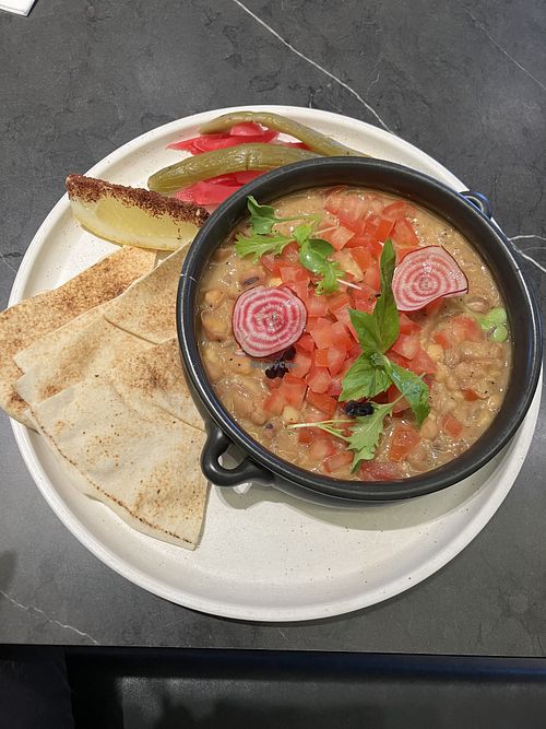 Fava Bean Breakfast (Foul moudamas) - stewed fava beans, chickpeas, lemon juice, garlic, olive oil, parsley, tomato, Lebanese bread with pickles & mint -$22.90  at Qube Kaffeine & Kitchen in North Parramatta