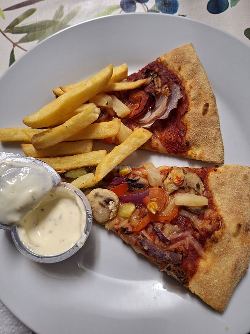 Pizza, fries and plant based garlic and herb dip at Domino's Pizza in Longford