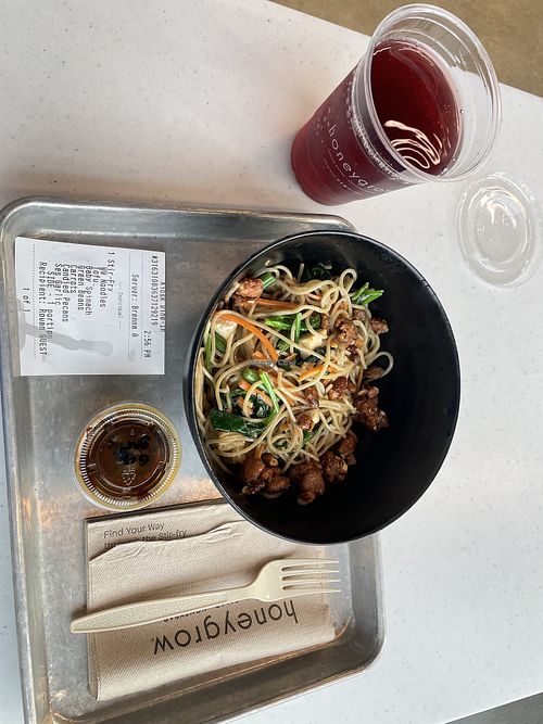 Whole wheat noodles topped with tofu, spinach, carrots, fresh green beans, pecans, and a sesame garlic sauce. Black cherry drink on the side    at honeygrow in Toms River