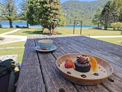 Chocolate mud cake and oat milk flat white at Furneaux Lodge in Furneaux