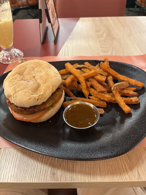 Vegan burger with peppers, avocado and chilli sauce with sweet potatoe fries.  at VIPS  in Ceuta