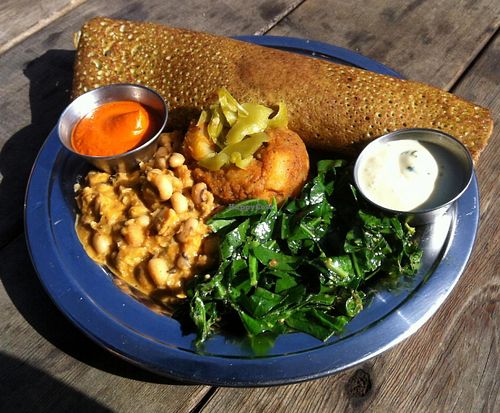 Red-lentil dosa plate- size small, $7 for happy hour! Kale-red lentil dosa, black eyed pea korma, potato masala, collards in warm dressing, pickled anaheim chilies, cilantro-lemon sauce, roasted red pepper-cashew chutney at The Sudra - 28th Ave in Portland