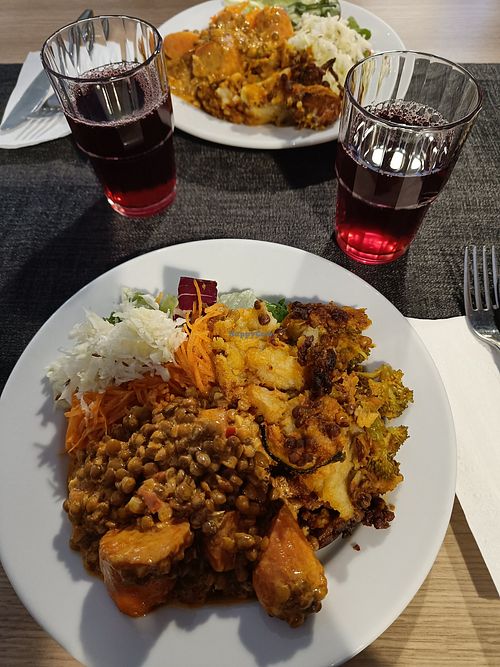Vegan carrot lentil curry, vegan shepherd's pie, and different salad options. Local berry juice. at Ravintola Hyvärilä in Nurmes