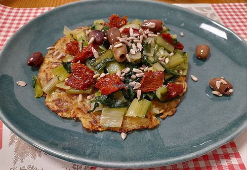 Potato fritters with turnip greens, dry tomato, Cailletier olives, sunflower seeds. at Osteria 33 in Piazza