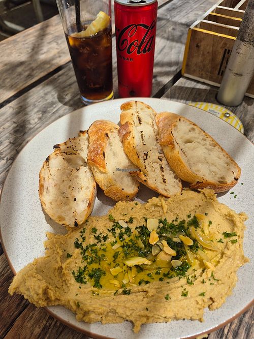Hummus, charred sourdough, crispy garlic, confit lemon, lemon oil at Bathers Beach House in Fremantle