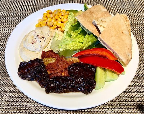 Hummus, muhammra, salad and bread  at Taybeh Restaurant in Aqaba