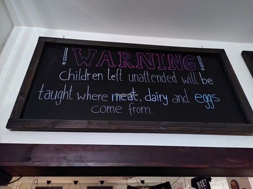 On the chalkboard today: "Warning! Children left unattended will be taught where meat, dairy, and eggs come from." at Bodhi in Munich