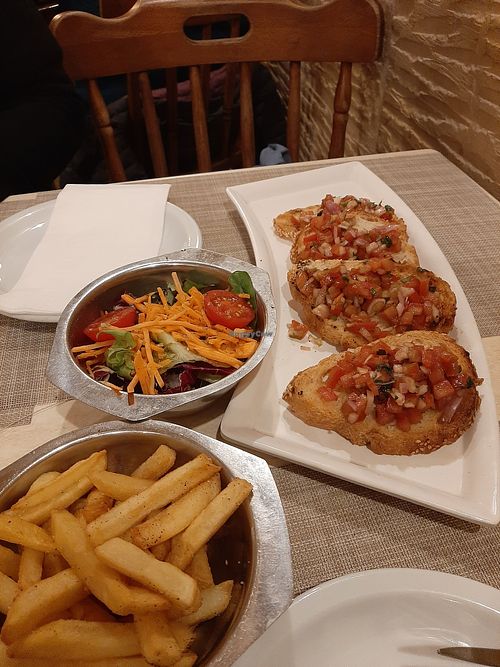 Starters and Sides: Bruschetta, Fries and salad at Matthew's Restaurant in Marsaxlokk