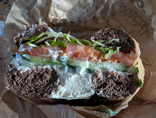 Pumpernickel carroway seed with vegan cream cheese cucumber tomato sprouts at Boichik Bagels - FiDi Battery in San Francisco