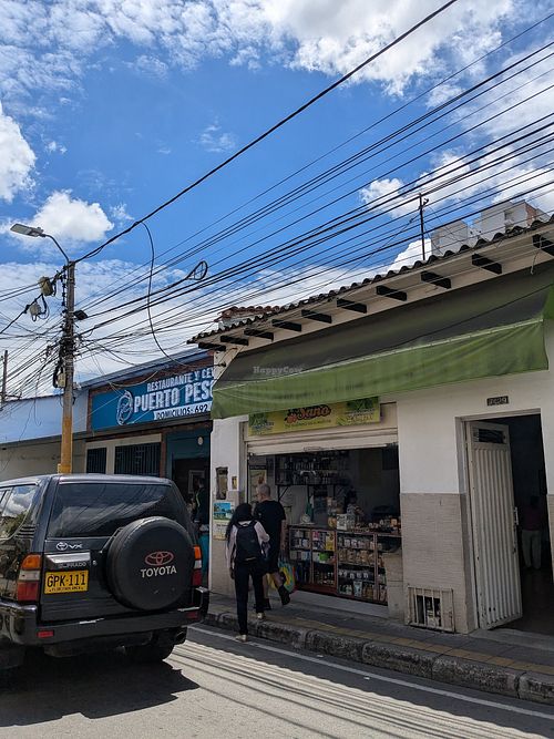 Street view (sign is hidden by green banner) at Viva Sano in Floridablanca