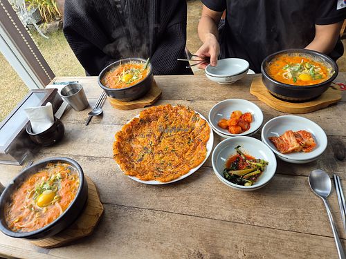 Kimchi stew (with eggs (ask to omit if you'd prefer without) and kimchi pancake. at Sinbaengi Kimchi in Jeonju