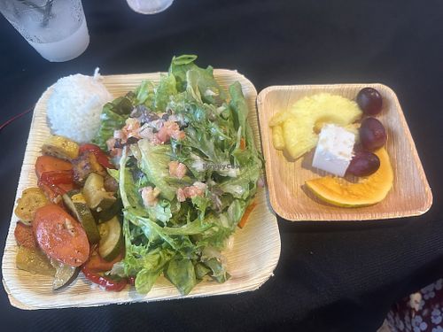 Vegetable tofu stir fry, sticky white rice, salad, and fruit pictured. Options depend on availability, must email ahead so they can prepare the dish for you.  at Toa Luau in Haleiwa