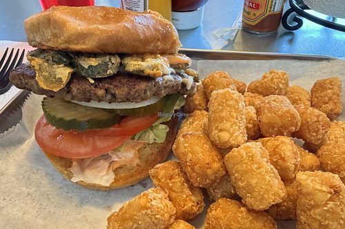 Delicious Impossible burger with vegan cheese, vegan sauce, lettuce, onion, tomato, pickle, fried jalapeños.  at Scottie B's Burgers  in Chattanooga