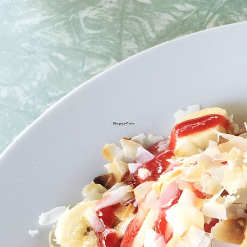 Vegan pancakes with coconut yoghurt, fresh fruit and raspberry coulis  at Petty Cash Cafe in Marrickville