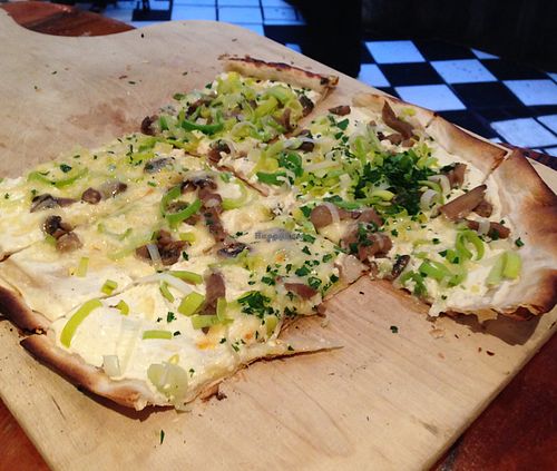 Flammkuchen - seasonal tarts flambé with seasonal mushrooms, leeks, creek fraiche and cheese at TIAN Bistro Kunsthaus in Vienna