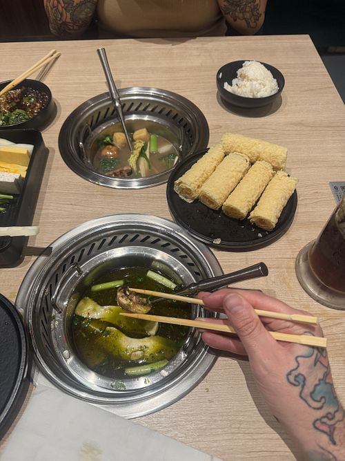 Miso and green chili broth in picture with the veggie combo  at Mumu Hot Pot in Emeryville
