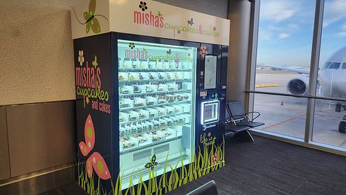 Two vegan cupcake options listed in the vending machine at MIA - Misha's Cupcake in Miami