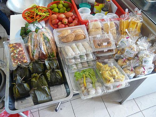 Small table with sandwiches, cookies, springroll, pizza bread, etc. at Jay - City Center in Udon Thani