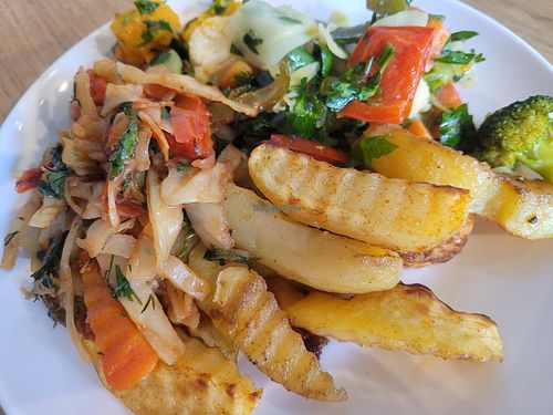 Massive plate of roast vegetables with chimichurri, braised cabbage in tomato sauce, and roast potato wedges. Everything was SO tasty! at Art Lunch in Yerevan