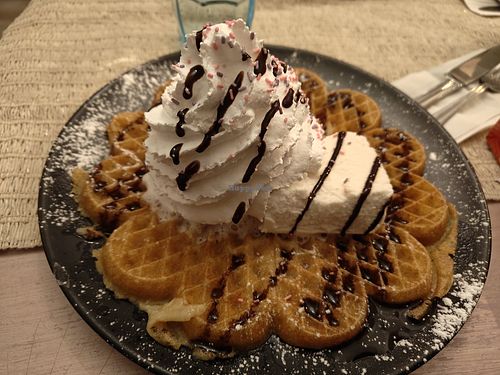 Vegan gluten free waffle with chocolate sauce, whipped cream and ice cream. at Kuparitalon Vohvelikahvila in Tampere