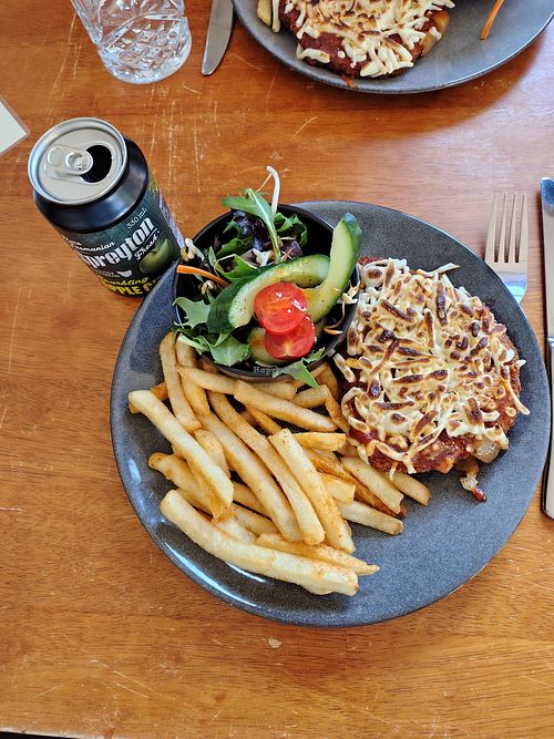 No chicken parmigiana with chips and salad and vegan cheese at Miners Gold Brewery in Beaconsfield