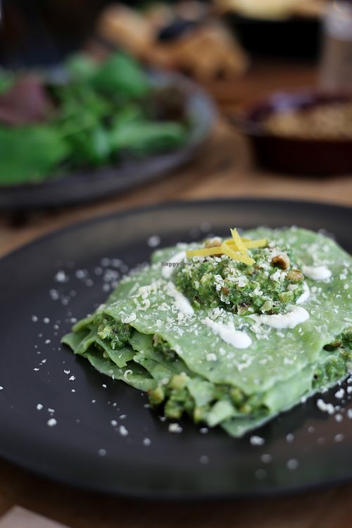 Open spinach ravioli with walnut pesto and cashew parmesan at Kaiaroha Vegan Deli and Eatery in Auckland