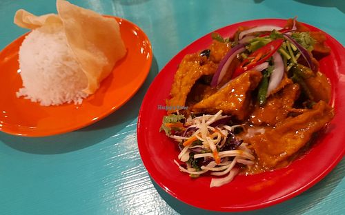 Malaysian curry sauce, tofu, sweet and sour cabbage salad, papadam chips and rice. at Street Canteen in Espoo