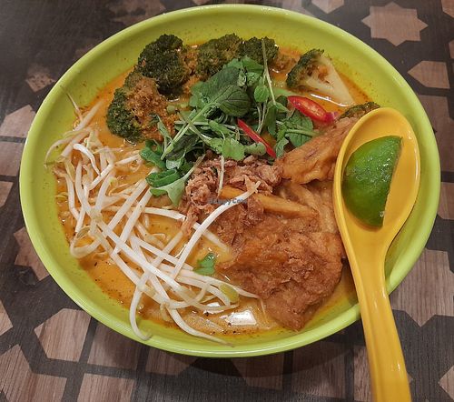 Vegan Mee Kari: noodles, hot curry-based soup, coconut milk, tofu, broccoli, vegetables and lime. at Street Canteen in Espoo