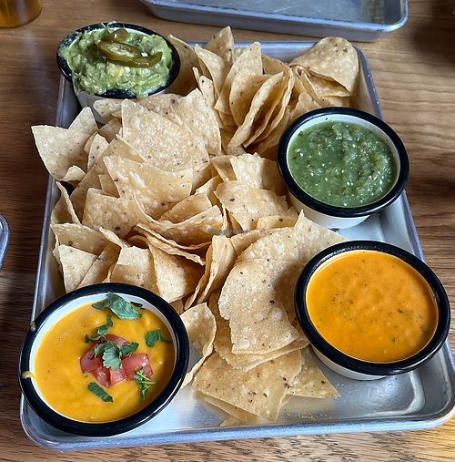Special chips, vegan queso and guac, green salsa and red salsa  at Lonesome Rose - Andersonville in Chicago