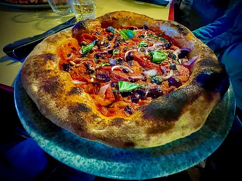 Pizza peperonata: tomato sauce, roasted red peppers, red onions, olives (taggiasche), capers, pine nuts  at Nuvole di Farina in Rome