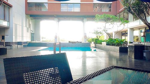 Tables by the pool at ATLANTIS in Padang
