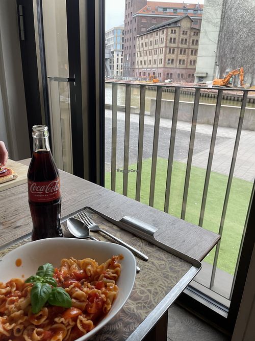 Pasta Pomodoro with Coca Cola and view of the Hafen Münster  at Vapiano - Hafenplatz in Muenster