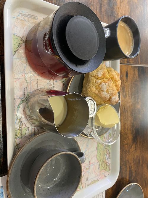 Vegan scone with dairy free spread and jam. Black tea and coffee with soya milk on the side.  at Artisans in Llanwddyn