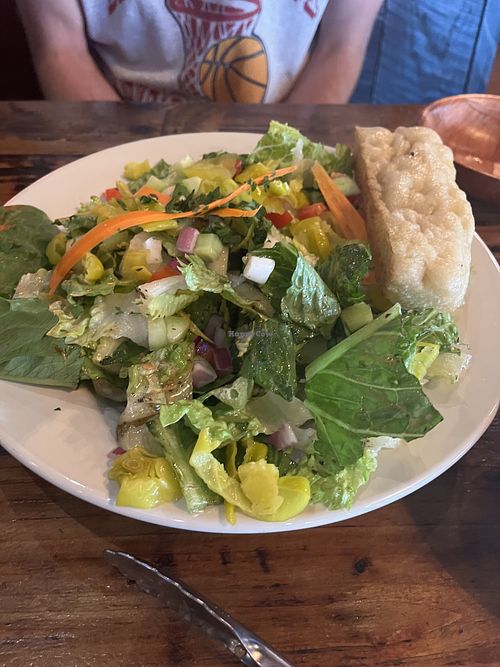 Corner Salad (or whatever their house salad was named!) minus parm & croutons. The Italian vinaigrette it’s served with is good for vegans   at Bricks Corner in Salt Lake City