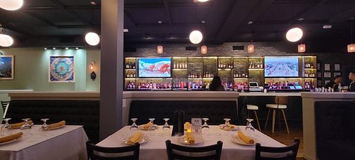 Full bar.  You can also see some of the paintings done by Buddhist monks and the TVs showing gorgeous scenes from Nepal. at Himalaya Sono in Norwalk