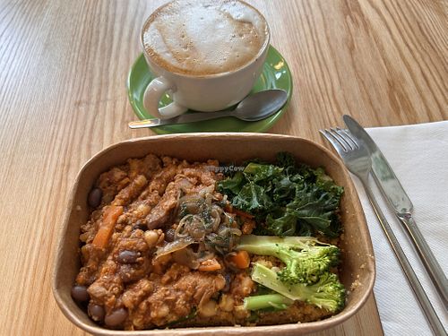 Slow cooked Persian vegan quorn, barley, bean and lentil stew, served with seasoned cauliflower rice. And soya cappuccino (oat milk also available).  at Nourish in Douglas