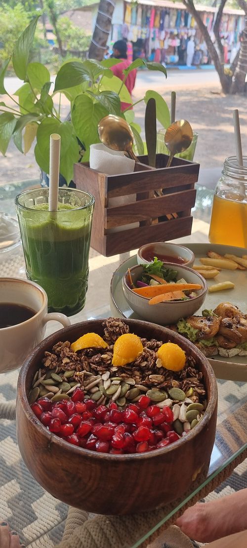 Mango bowl, avocado mushroom toast, gold kombucha, green detox juice and americano. at Urth Organic Cafe & Eatery in Vagator