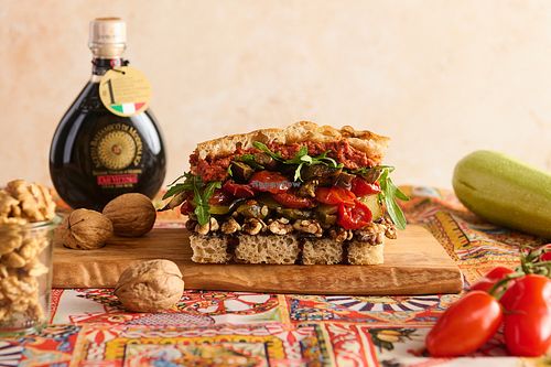 La Vegetale. Vegan Focaccia. Fresh focaccia with pesto rosso, walnuts, grilled zucchini, tomato, balsamico cream, rucola at La Posata in Frederiksberg