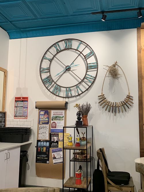 Interior shot with coffee trinkets and a non-functional giant blue wall clock to give a sense of the atmosphere  at LOKL CAFE in Morristown
