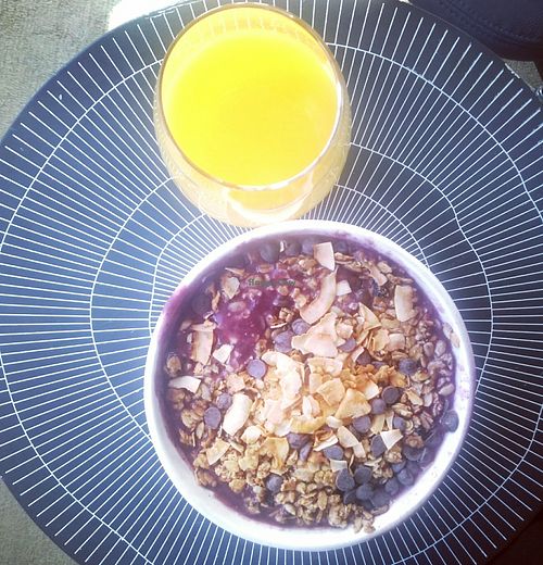 Açai bowl with granola, chocolate chips and coconut and a fresh orange juice at Juice Press - Lower East Side in New York City