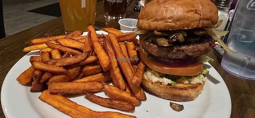 Vegan variation on The Blue Collar, substituted veggie burger, and avocado instead of blue cheese, added horseradish and sweet potato fries. at The Office Bar and Grill in Cheyenne