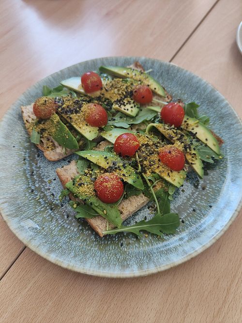 Tostada de aguacate con rúcula y tomate at Bliss  in Santa Maria De Palautordera