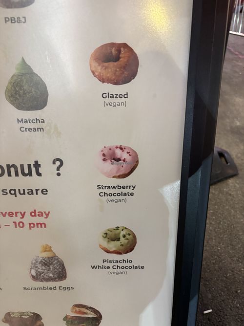 Sandwich board outside shows the 3 vegan donuts  at I'm Donut in New York City