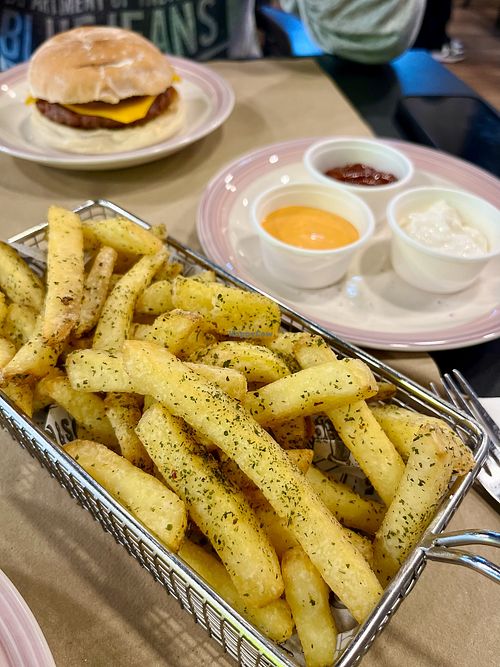 Spiced vegan fries: Belgian fries seasoned with thyme, parsley, paprika, rosemary, served with vegan sauces: aioli, bbq, and smoky sriracha at Baka Vieja Burger Shop in Gijon